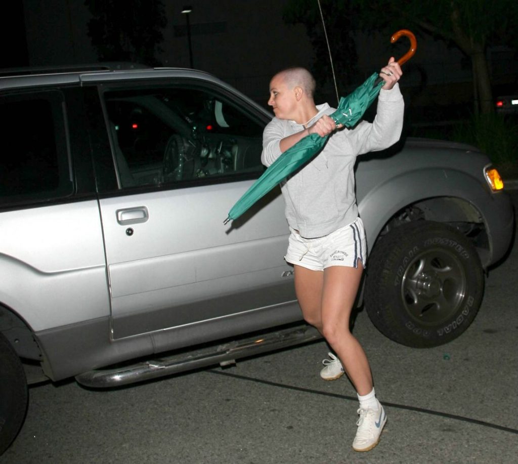 Britney hitting car with green umbrella